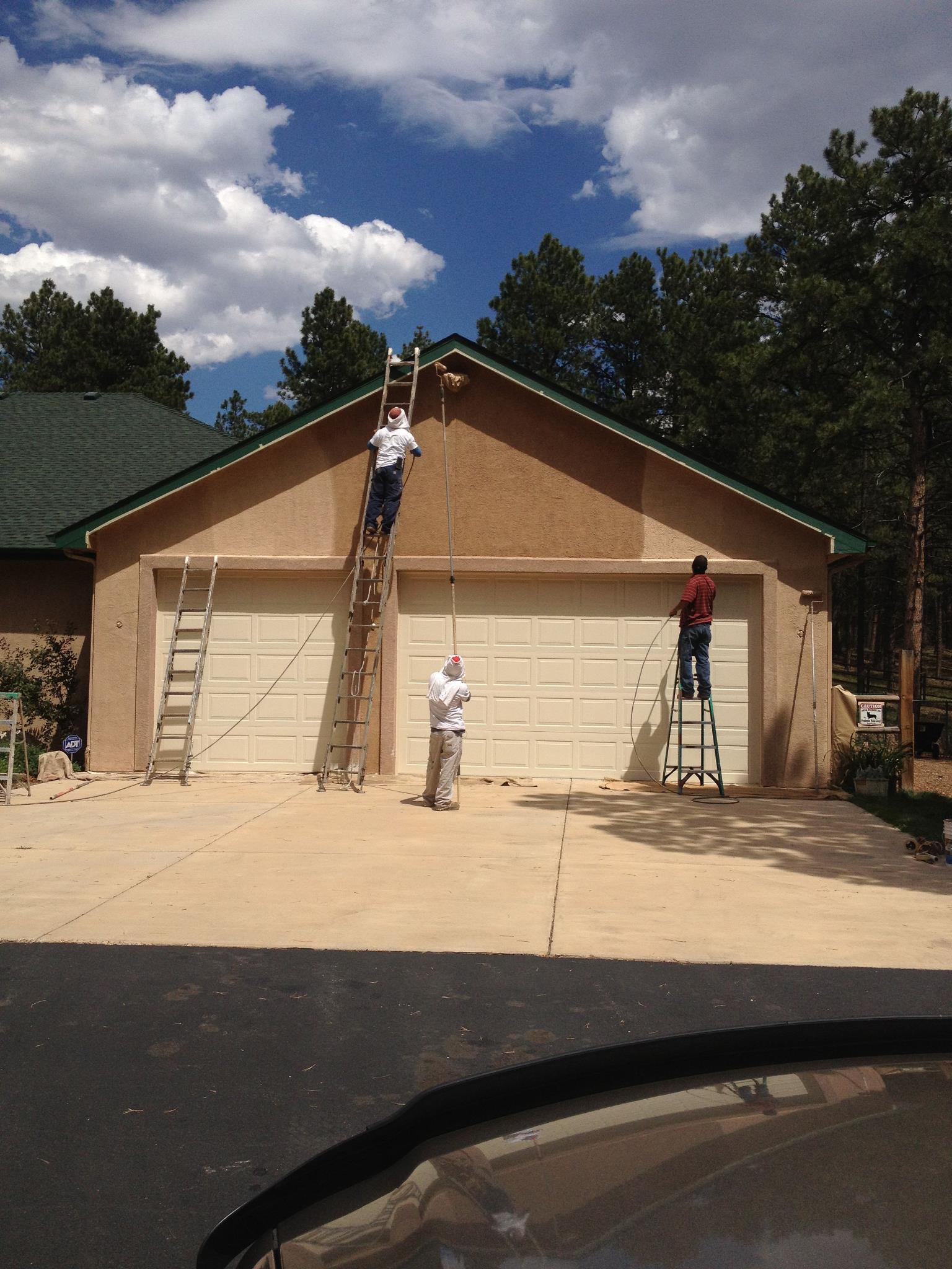 Confident Coatings crew painting a Colorado Springs home