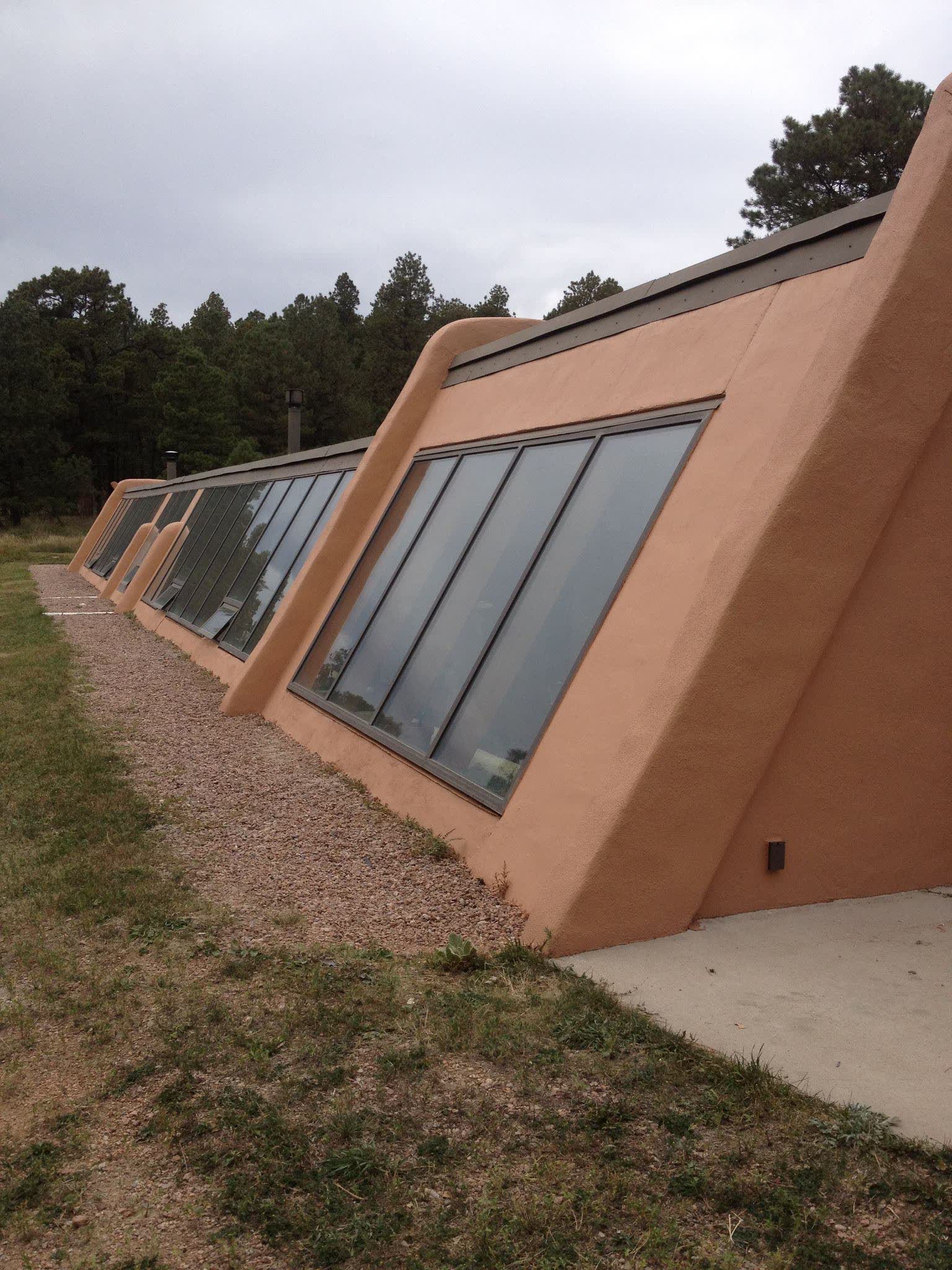 Modern peach-stucco architecture with angled glass walls
